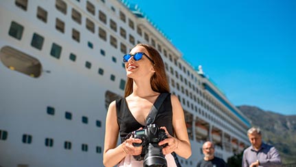 home holding a camera in front of a cruise ship