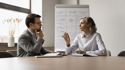 man and woman talking in an office