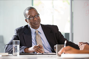 male employee sitting at meeting table