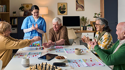 A caregiver and older adults enjoying a group activity.
