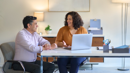 two women discussing paperwork