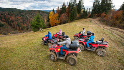 several ATVs at the top of a hill