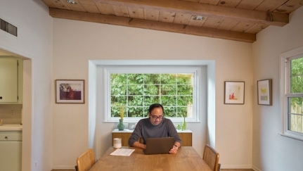 Man researching on computer in home