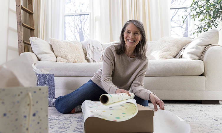 Smiling woman sitting in front of couch