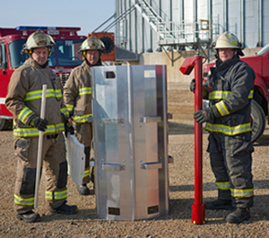 Firefighters with grain bin rescue equipment