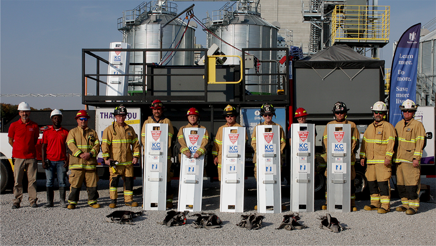 Firefighters holding grain rescue tub equipment
