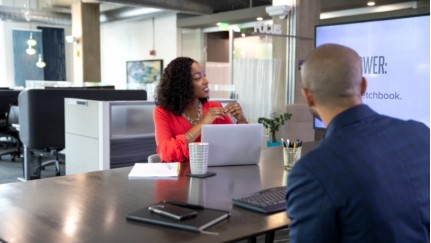 two people sitting in an office