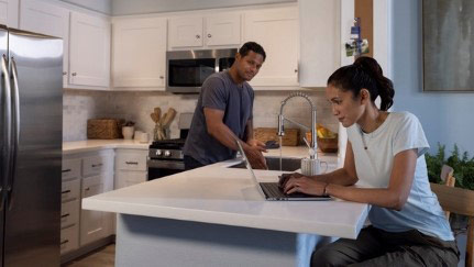 woman sitting at computer island looking at computer