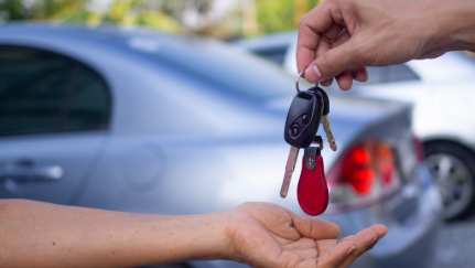 Traditional car keys sitting on center console of a car.