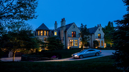 a car pulls out of a driveway at night