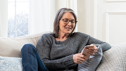 person using mobile device at home