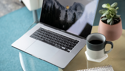 laptop and cup of coffee on desk