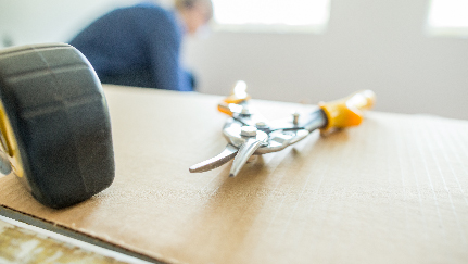 woman holding tape and talking to man