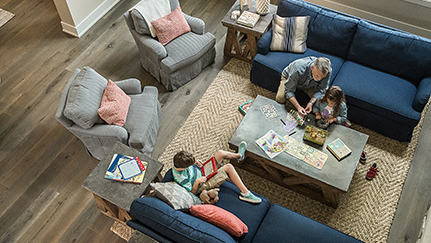children playing with their grandparent in living room