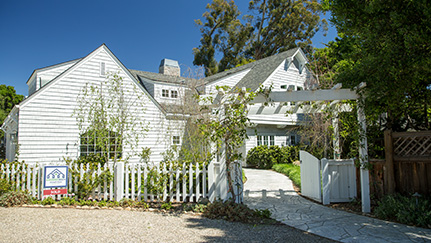 white house with a for sale sign