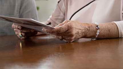 elderly woman reviewing documents