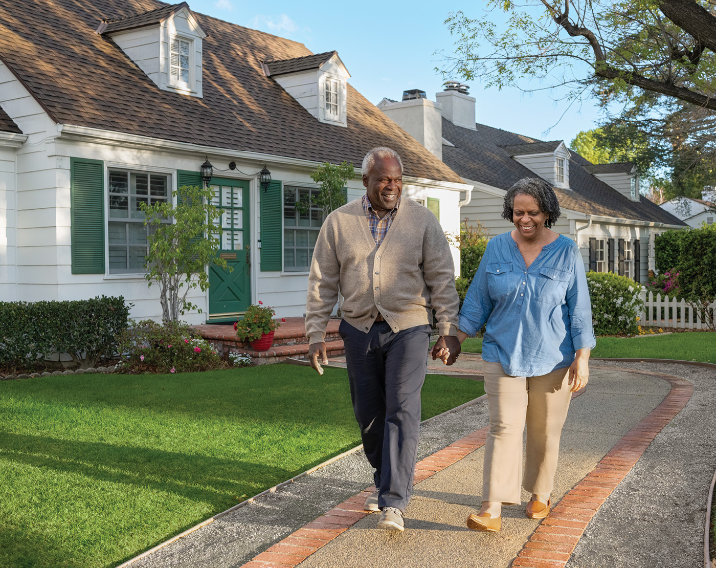 A retired couple takes a walk through their neighborhood