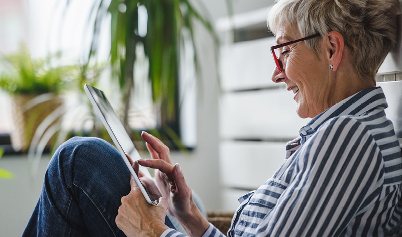 a woman nearing retirement age explores annuity options on her tablet