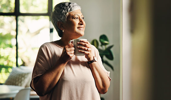Woman smiling while holding coffee cup