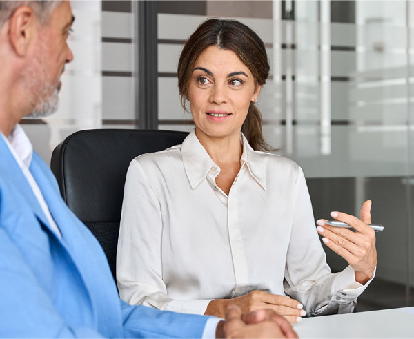 Image of a financial professional and a client sitting at a desk talking