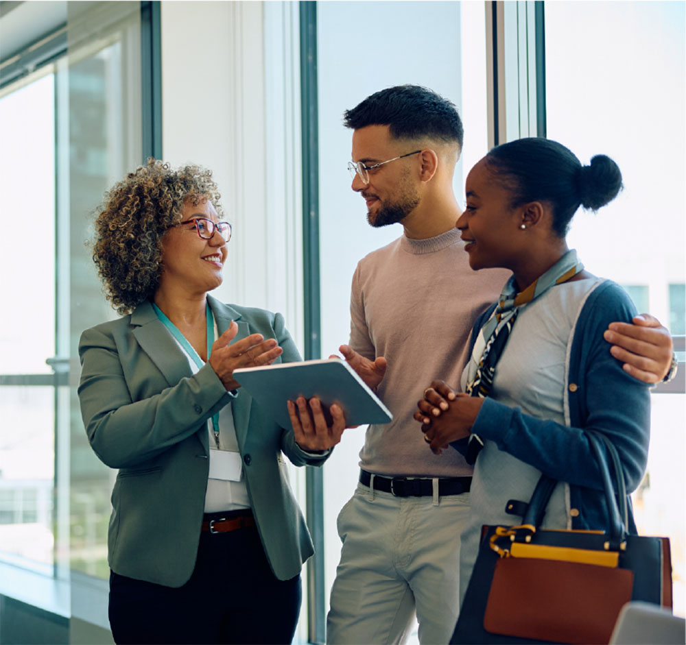 Gen z couple talking with a financial professional and looking at a tablet