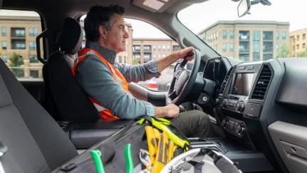 contractor driving a construction fleet vehicle