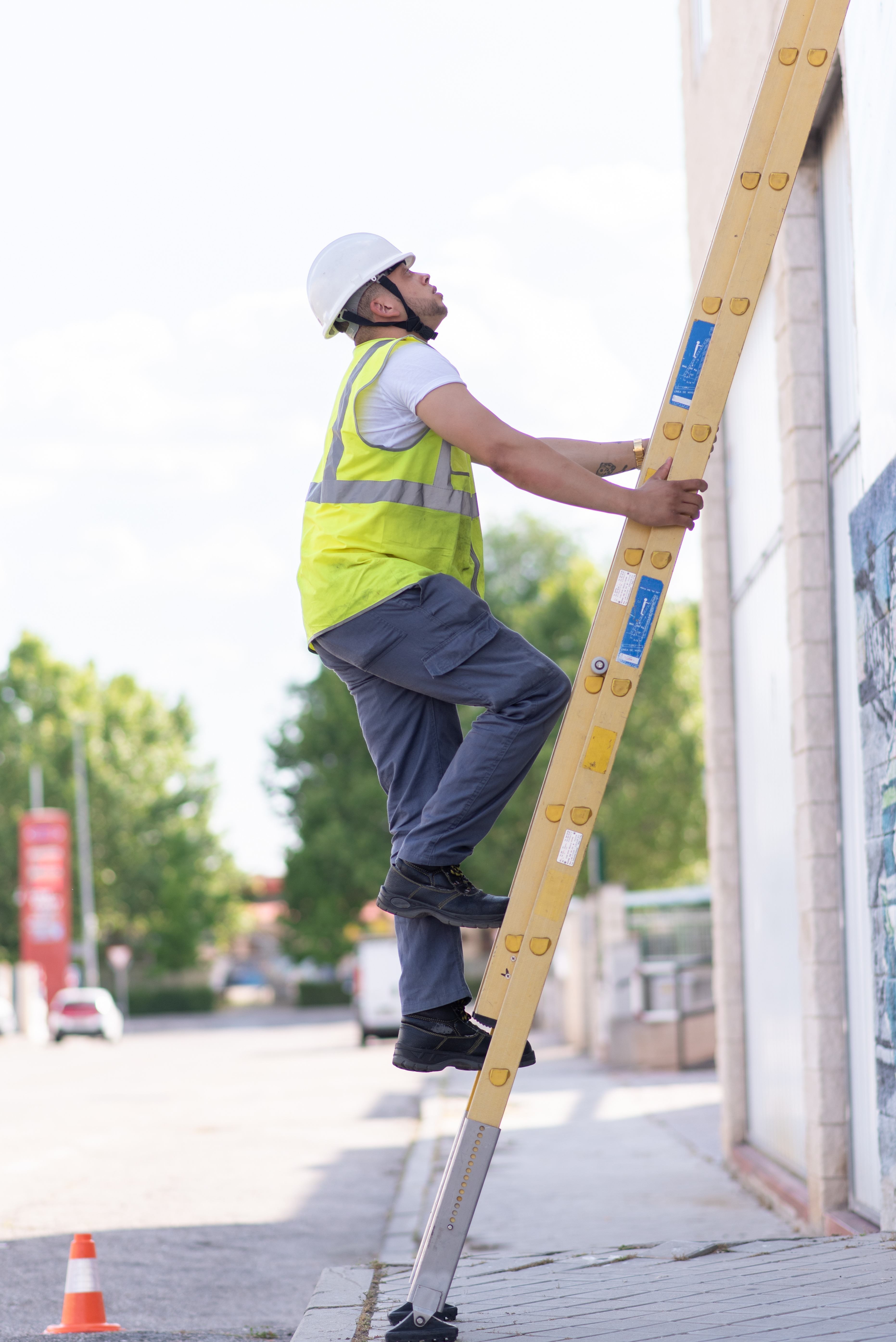 Worker climbing a ladder