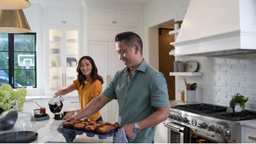 Man and woman working together in the kitchen.