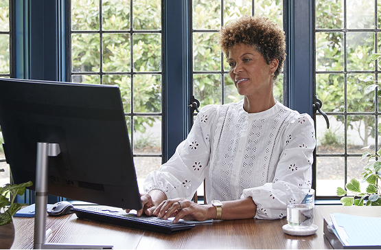 Sarah sitting at her desk in her home office discovering more about annuities.