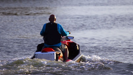 man and woman on jet skis