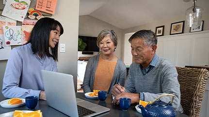 woman reviewing information on laptop with her parents